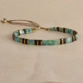 Geometric glass and coloured glaze beaded bracelet in milky white, black, green, blue, or red.
