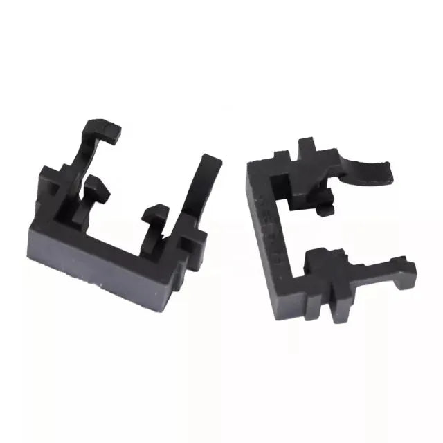 Black plastic LED headlight adapter holder for Ford cars, shown next to a ruler for scale.