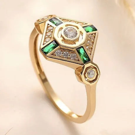 Square geometric women's ring with green diamond colour on a hand.