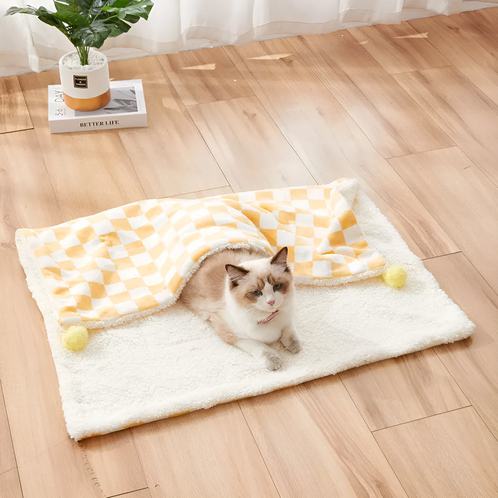 Plush pet blanket with plaid pattern and fur ball decoration for cats and dogs