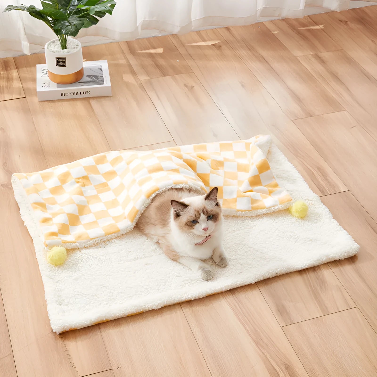 Plush pet blanket with plaid pattern and fur ball decoration for cats and dogs
