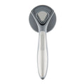 Grey self-cleaning slicker brush for pets with one-click button and comfort-grip handle on a table.