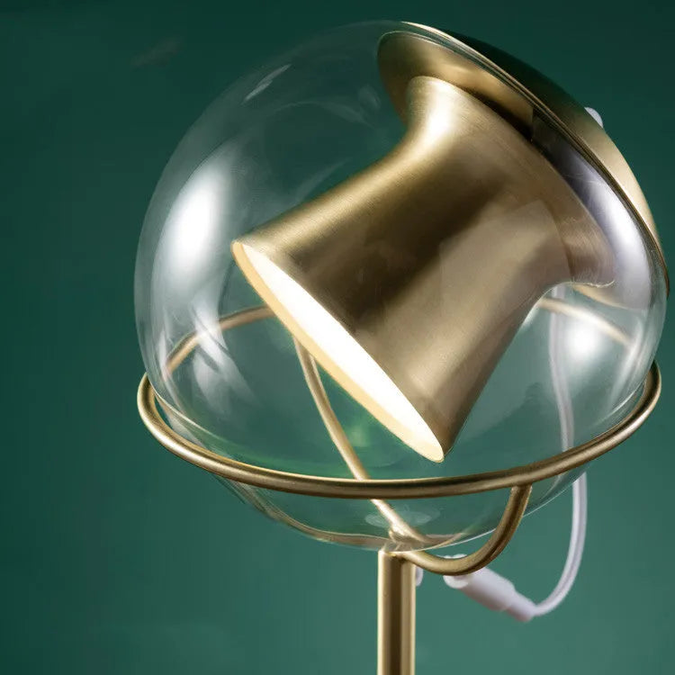 Glass desk lamp with dimmable touch control and LED light source on desk surface