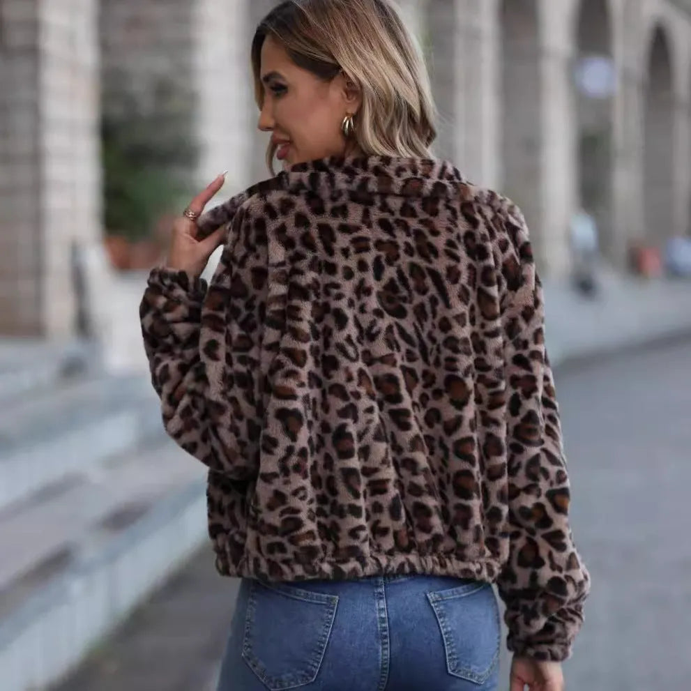 Women's loose leopard print plush coat with front zipper and raglan sleeves on a hanger.
