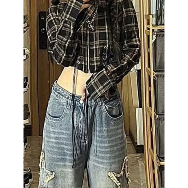Blue high-waist wide-leg women's jeans on a model, showing the straight-leg cut and denim texture.