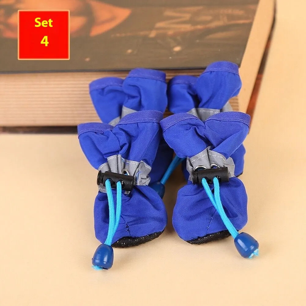Multicolour set of four breathable cloth dog shoes with non-slip soft bottom on a white background
