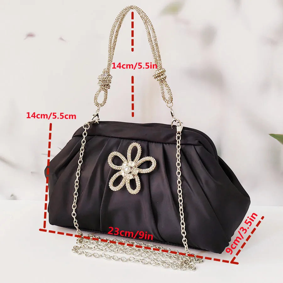 Women's black shell shape crossbody bag with diamond pattern and chain details showing internal document compartment