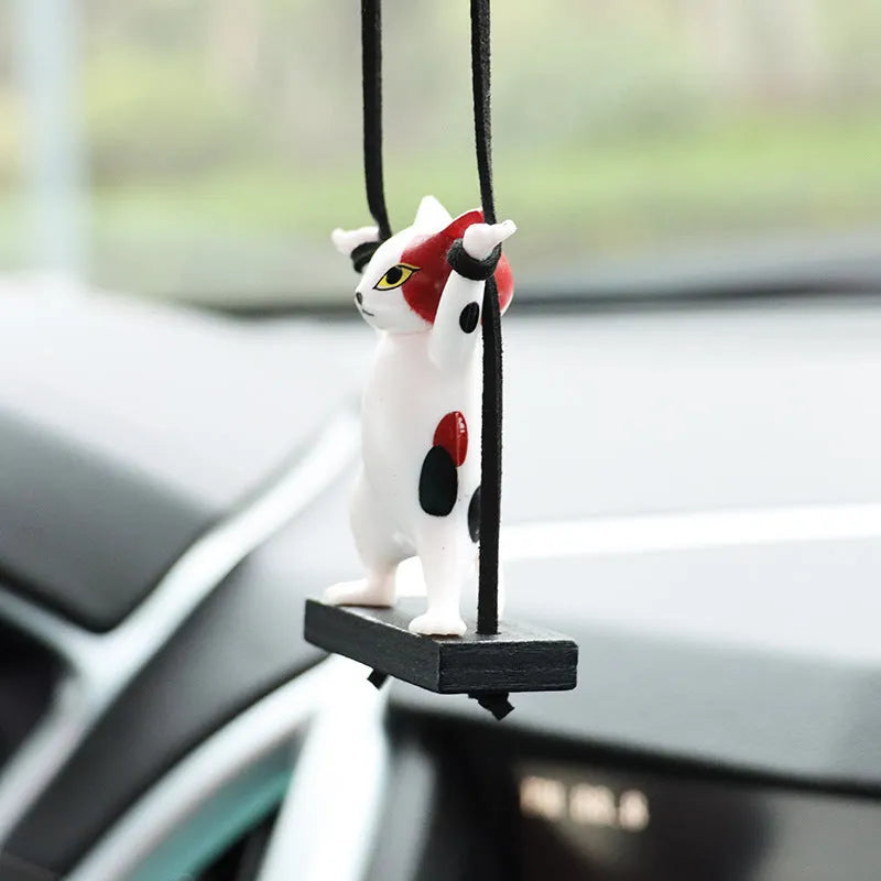 Cartoon-style resin cat pendant on a 25cm rope for hanging from a car rear-view mirror.