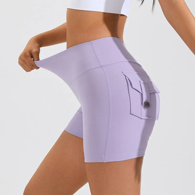 Women's high-waisted fitness shorts with pockets in quick-dry nylon fabric, shown in avocado green colour
