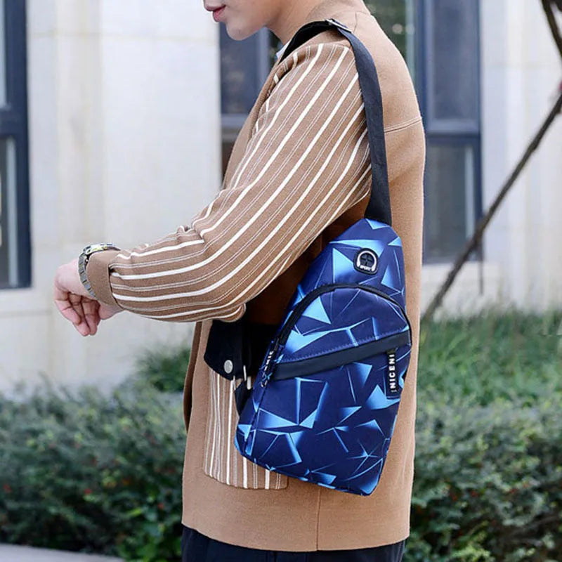 Men's blue Oxford cloth crossbody sling bag with an earphone hole and zipper, shown in a square vertical shape.