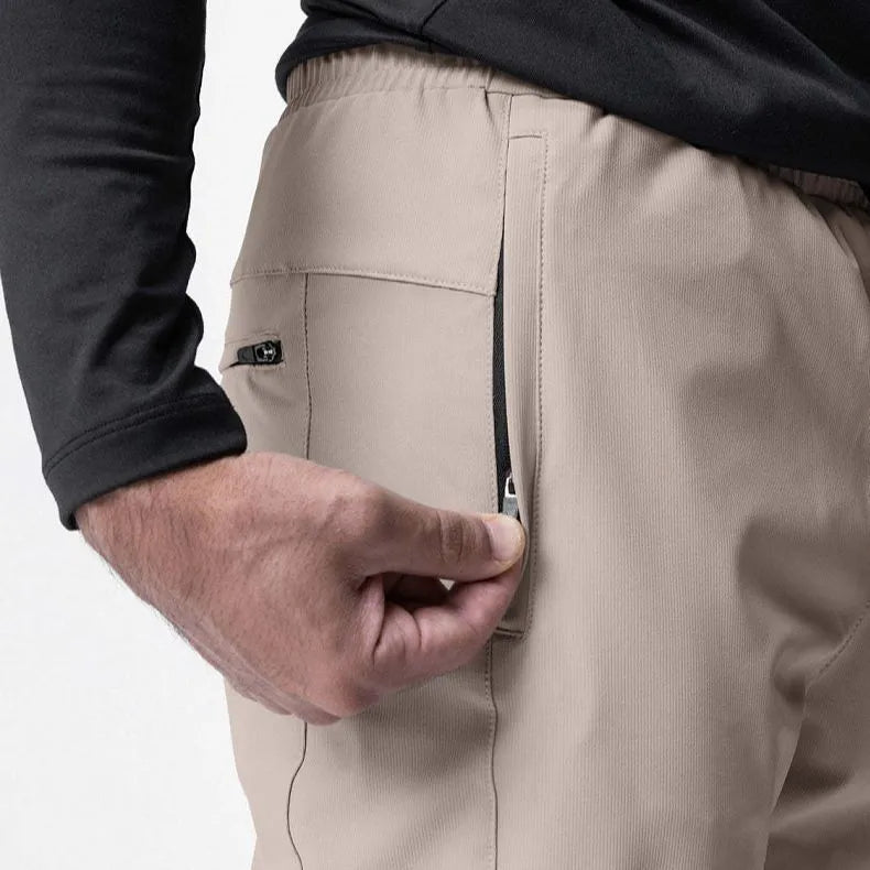 Men's grey quick-dry fitness pants with ankle ties shown in loose fit for exercise