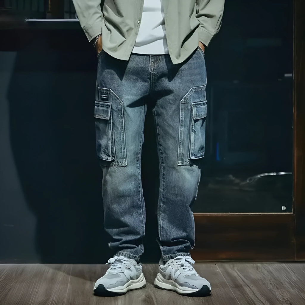 Man wearing blue loose straight-leg retro style stretch denim casual trousers