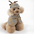 Camel-coloured detective-style cotton cloak for a small dog on a harness, showing the adjustable hat.