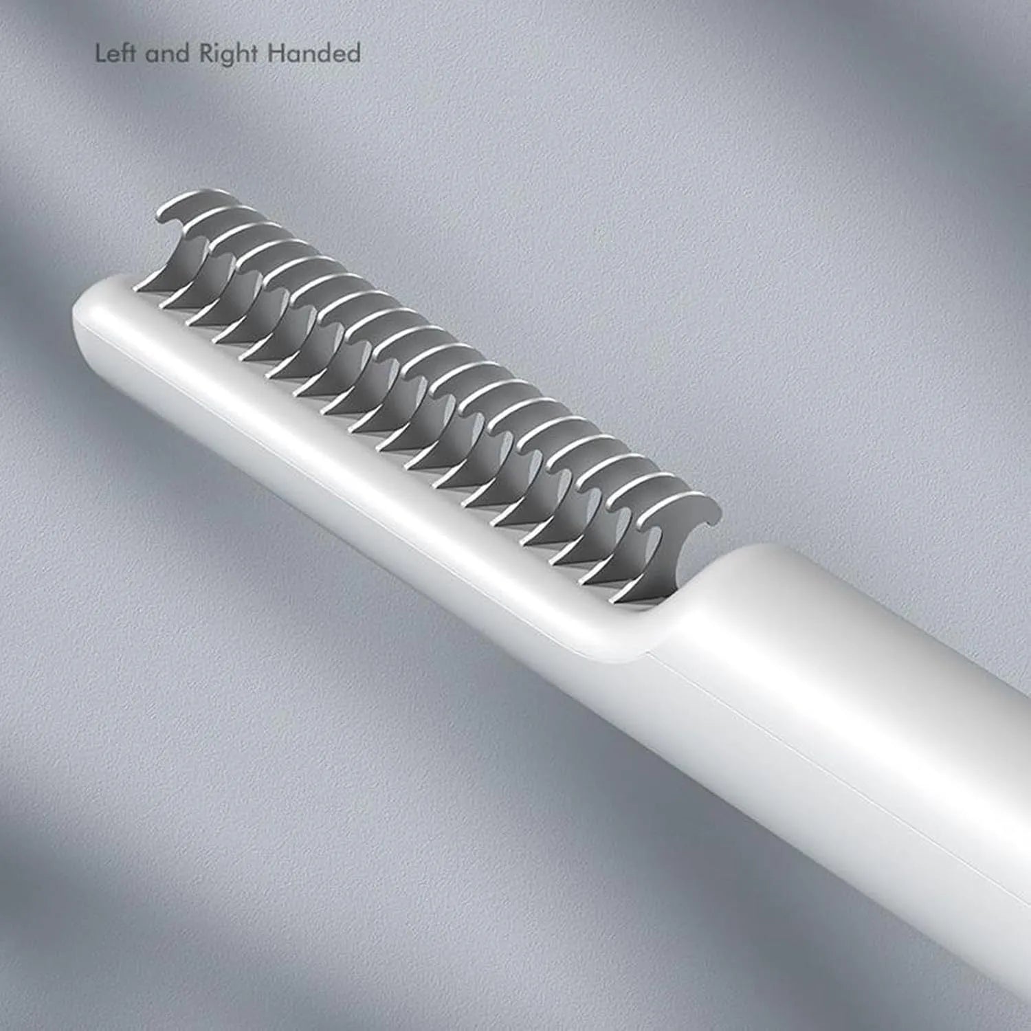 Stainless steel pet dematting comb with rake teeth and a handle for grooming dogs.