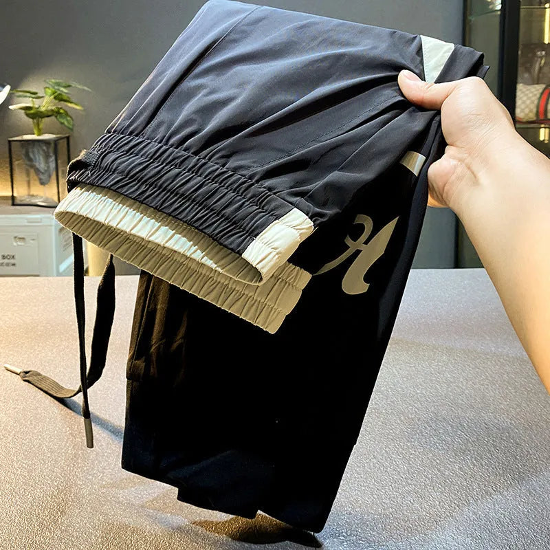 Man wearing black ultra-thin ice silk cotton ankle-banded cropped casual trousers