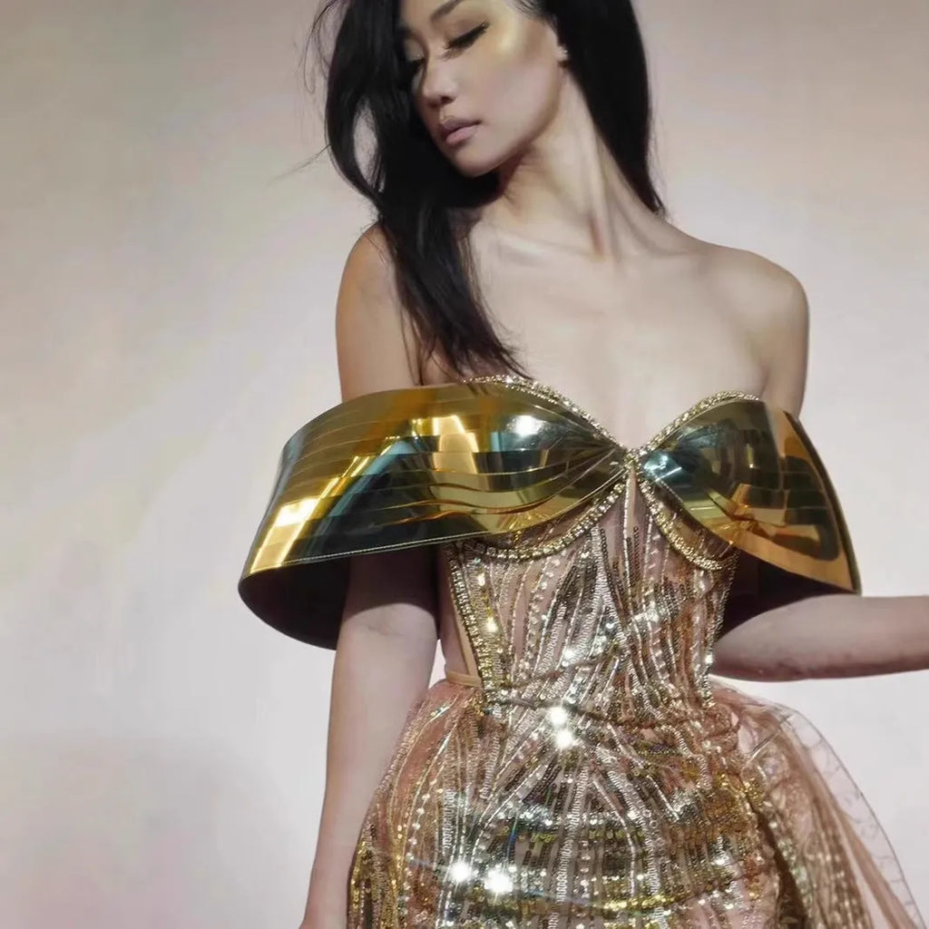 Gold strapless sequined long dress with tulle skirt and side slit detail.