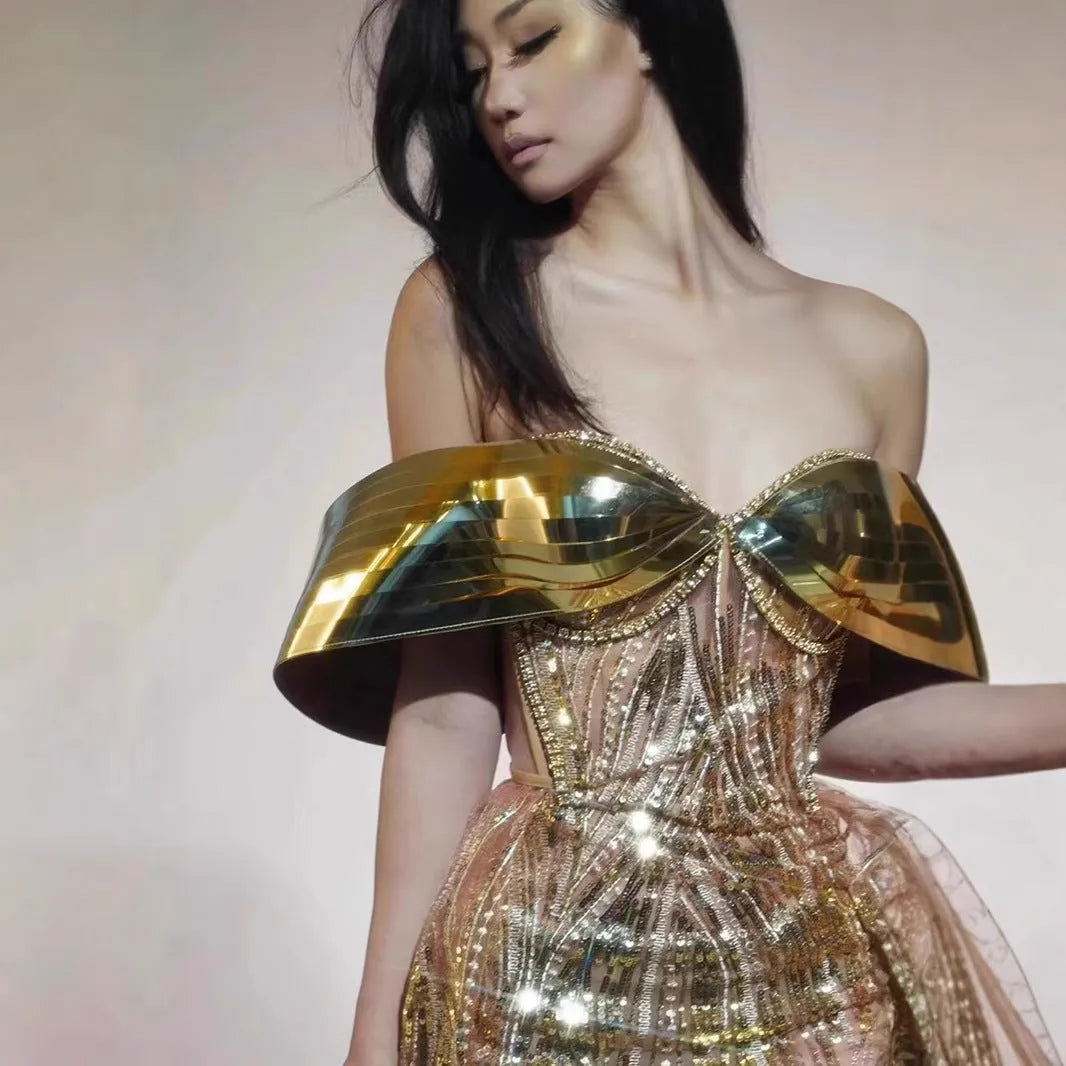 Gold strapless sequined long dress with tulle skirt and side slit detail.