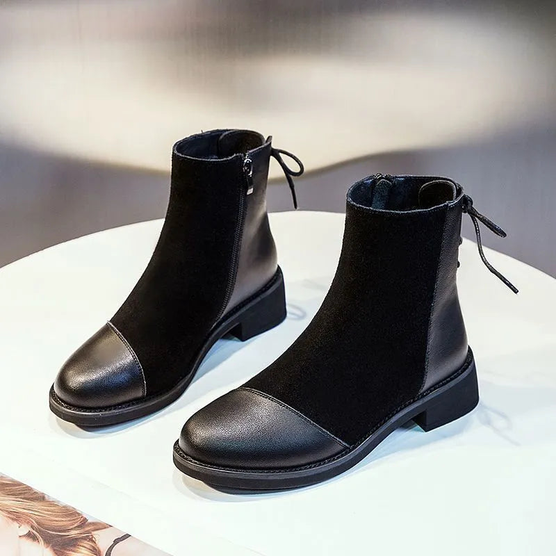 Women's black Martin boots with side zipper, round toe, and decorative bow detail