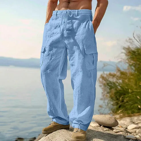 Men's loose cotton wide-leg trousers in light army green, shown in a casual setting.