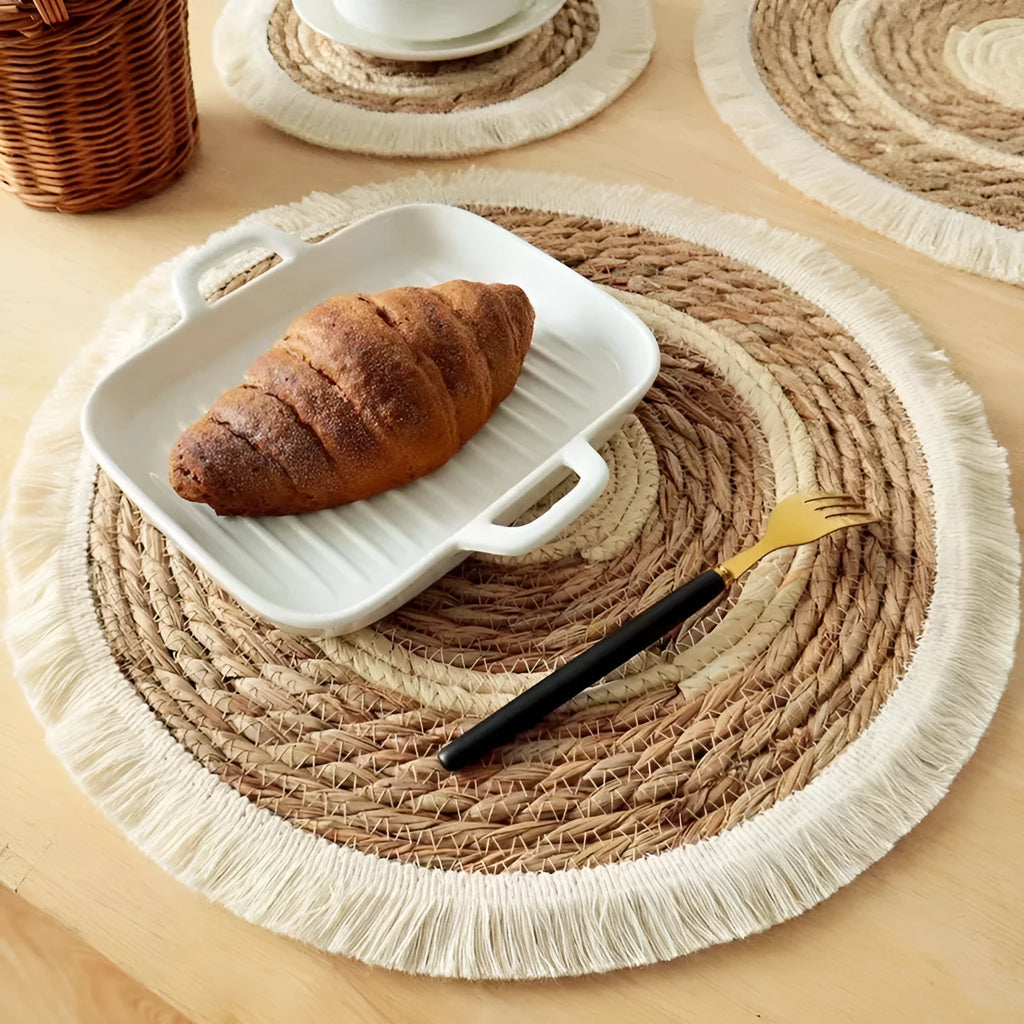 Round natural papyrus straw placemat with tassel detailing in 25cm, 30cm, 33cm, and 38cm sizes.