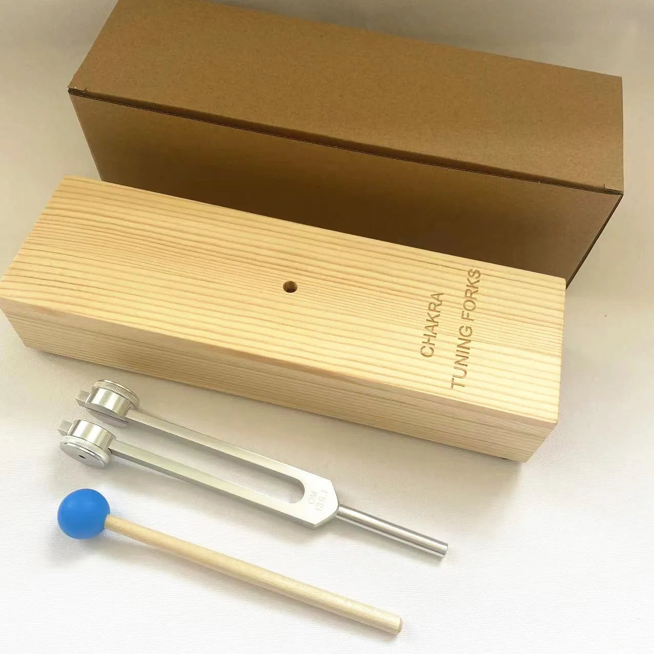 Aluminium alloy 432Hz tuning fork and speaker set for sound therapy in a kraft paper box.