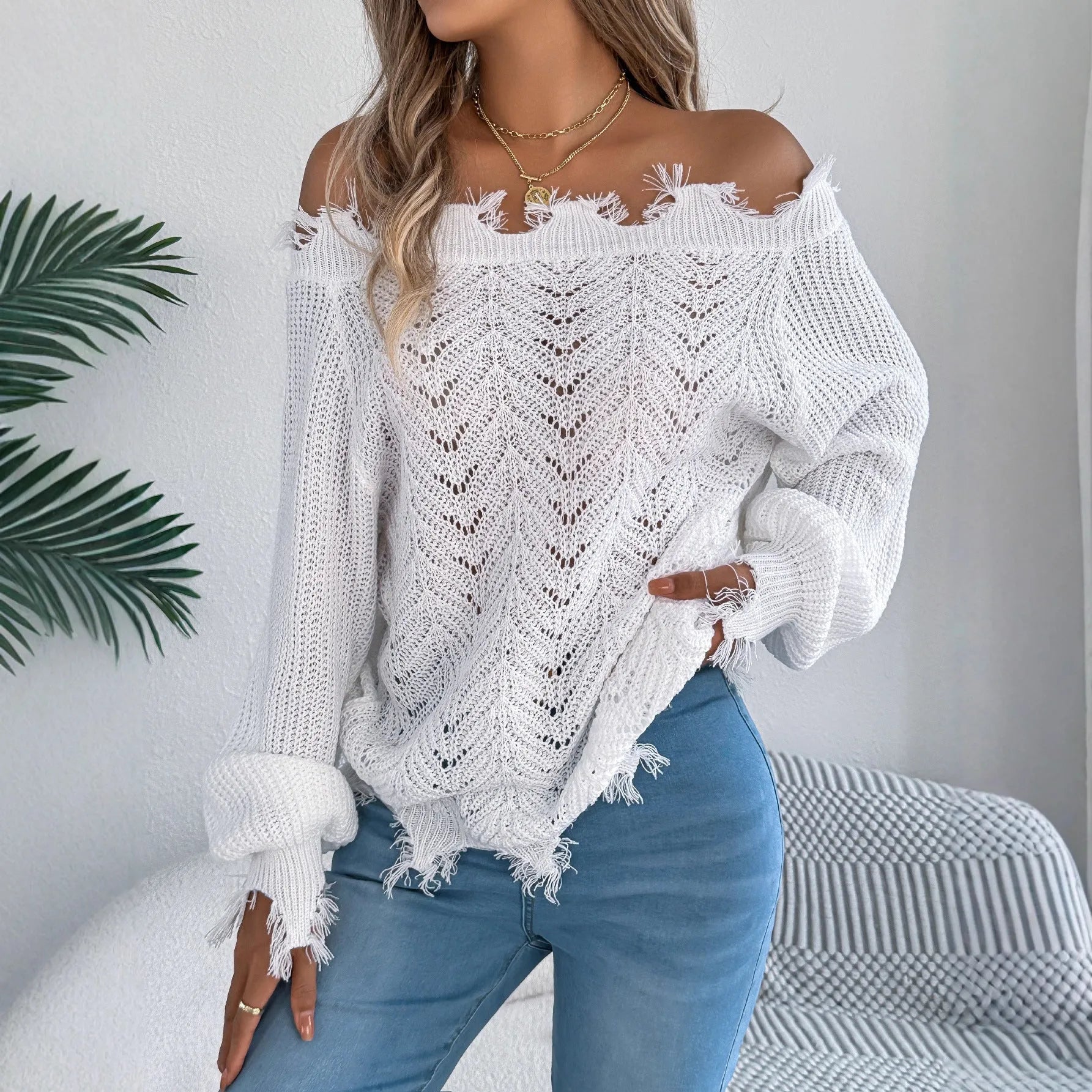 White cut off-the-shoulder pullover sweater with hollow-out long sleeves and street fashion styling