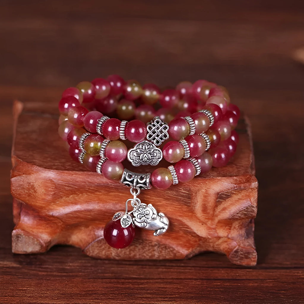 Natural watermelon crystal Chinese knot bracelet with elephant style beads.