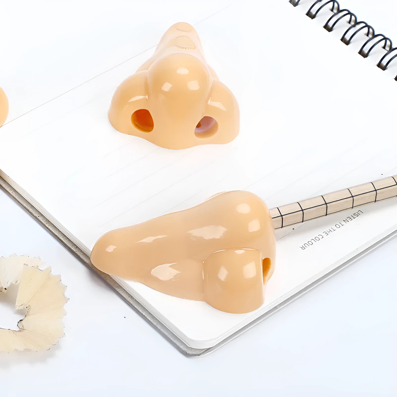 Flesh colour plastic pencil sharpener showing geometry design and large nostril hole