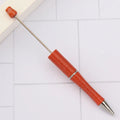 Creative ballpoint pen with a spinning bead, shown in a pearlescent colour variant, length 147mm.