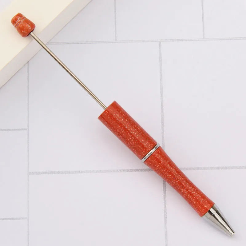 Creative ballpoint pen with a spinning bead, shown in a pearlescent colour variant, length 147mm.