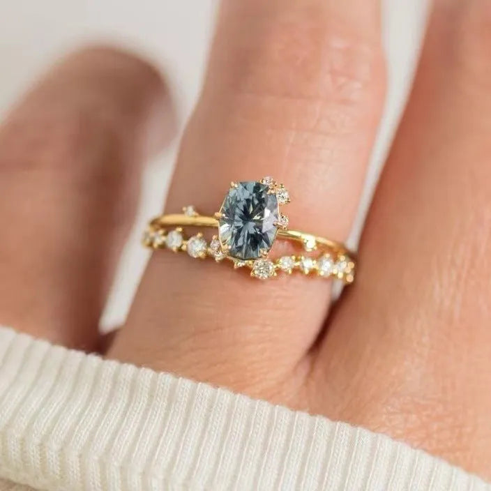 Gold plated alloy ring with floral design and green zircon stone, shown in various sizes