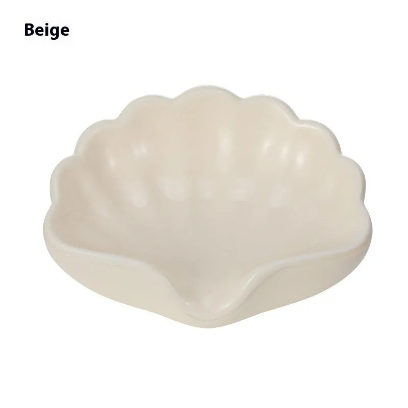 Pearl white plastic shell-shaped soap dish with drainage channels measuring 12cm long
