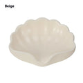 Pearl white plastic shell-shaped soap dish with drainage channels measuring 12cm long