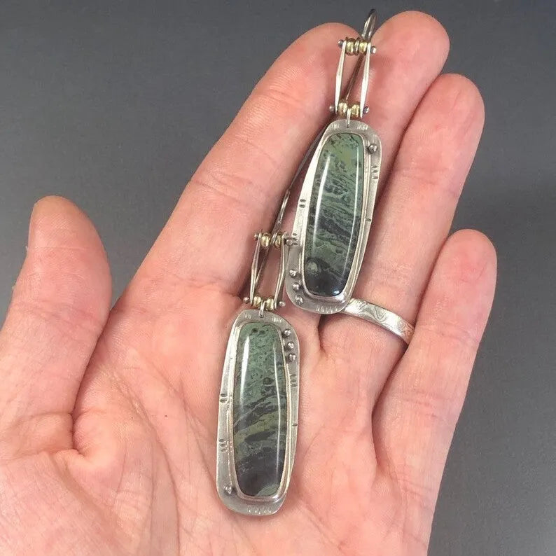 A pair of simple geometric alloy earrings with a two-tone marble pattern finish.