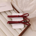 Wine red leather bow hair barrettes showing bow design and leather material