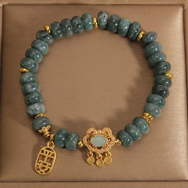 Natural emerald jade bracelet for women with abacus beads and a safety lock clasp on a white background.