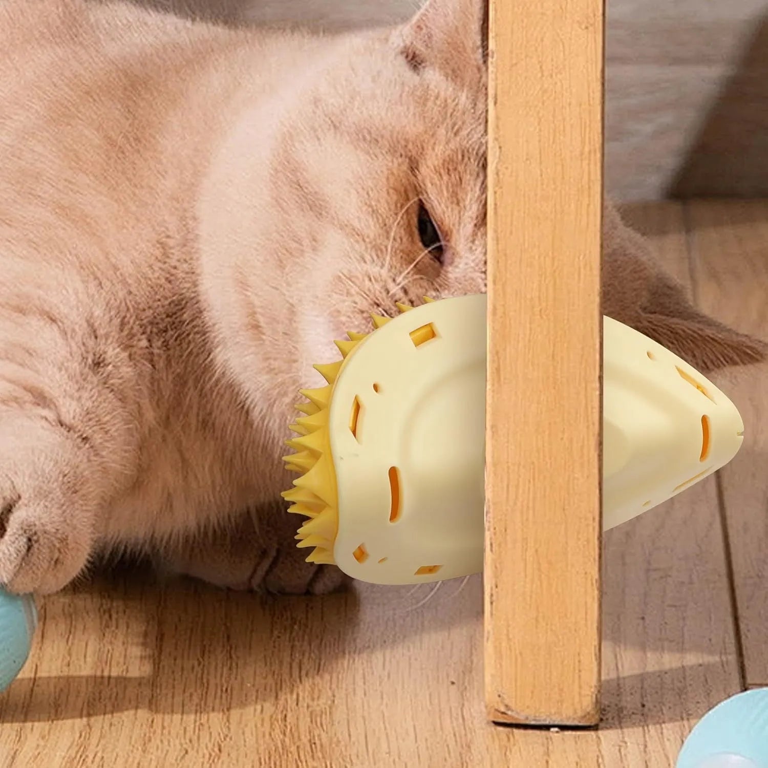 Yellow durian-shaped cat corner scratcher mounted on a wall with adhesive, includes catnip powder.