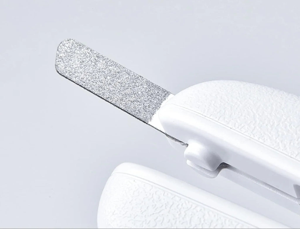 White pet nail clippers with LED light, transparent guard, and a separate nail file on a plain background.