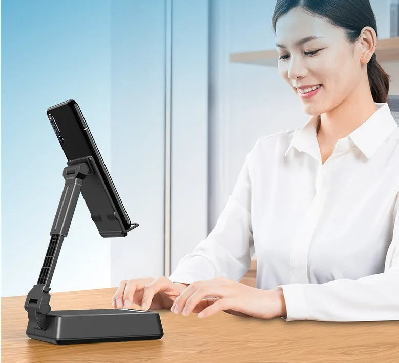 Black mobile phone broadcaster stand with Bluetooth speaker and microphone on a desk