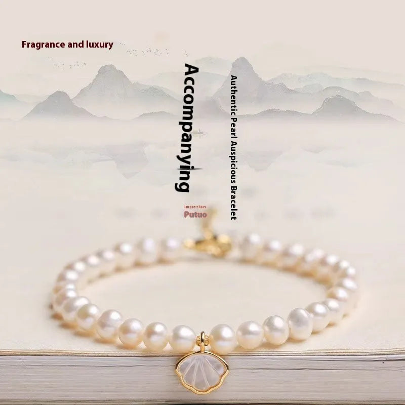 Women's freshwater pearl bracelet with fan-shaped shell design on 16cm elastic or extension chain