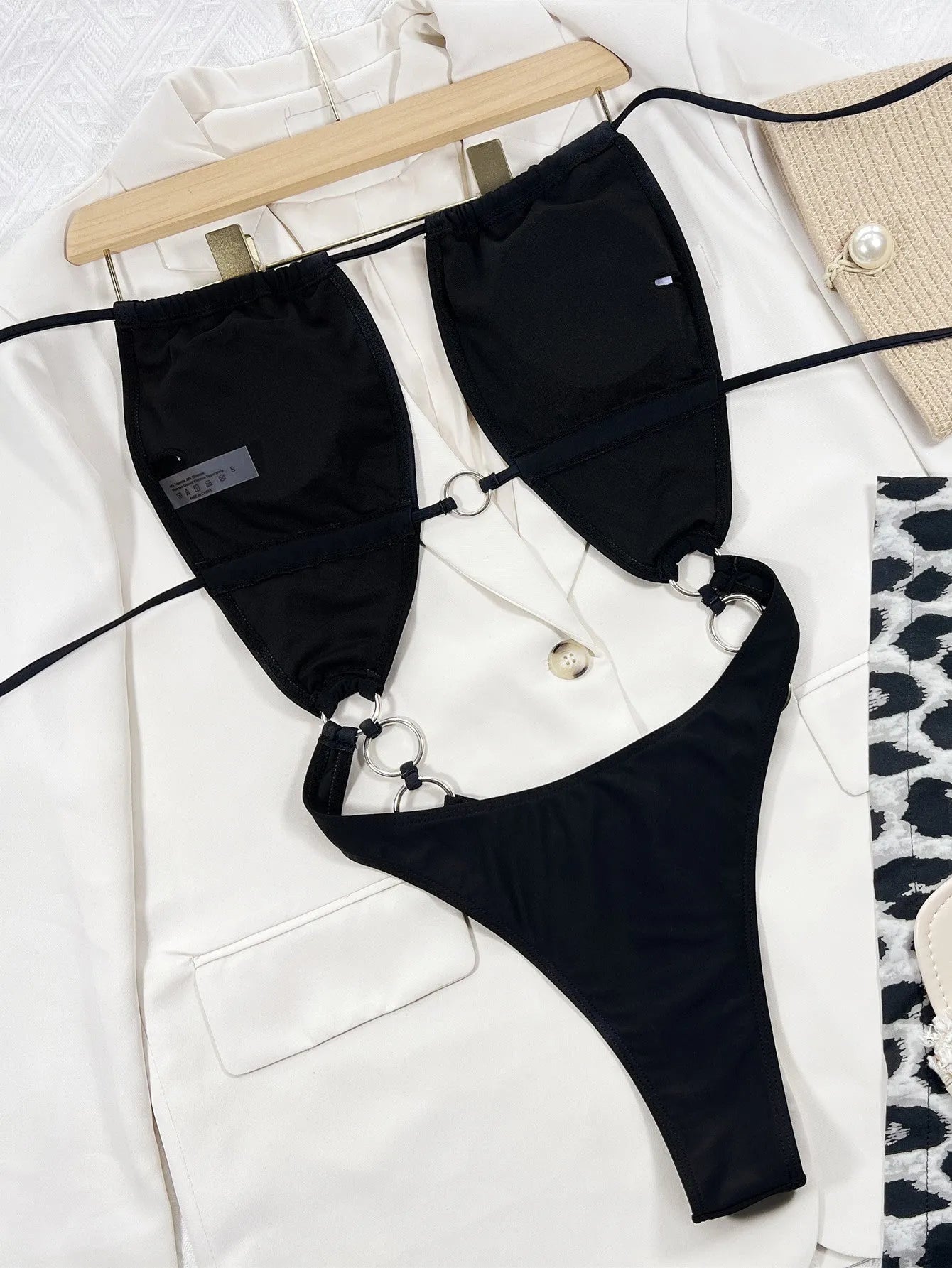A solid black women's sleeveless one-piece swimming suit on a mannequin.
