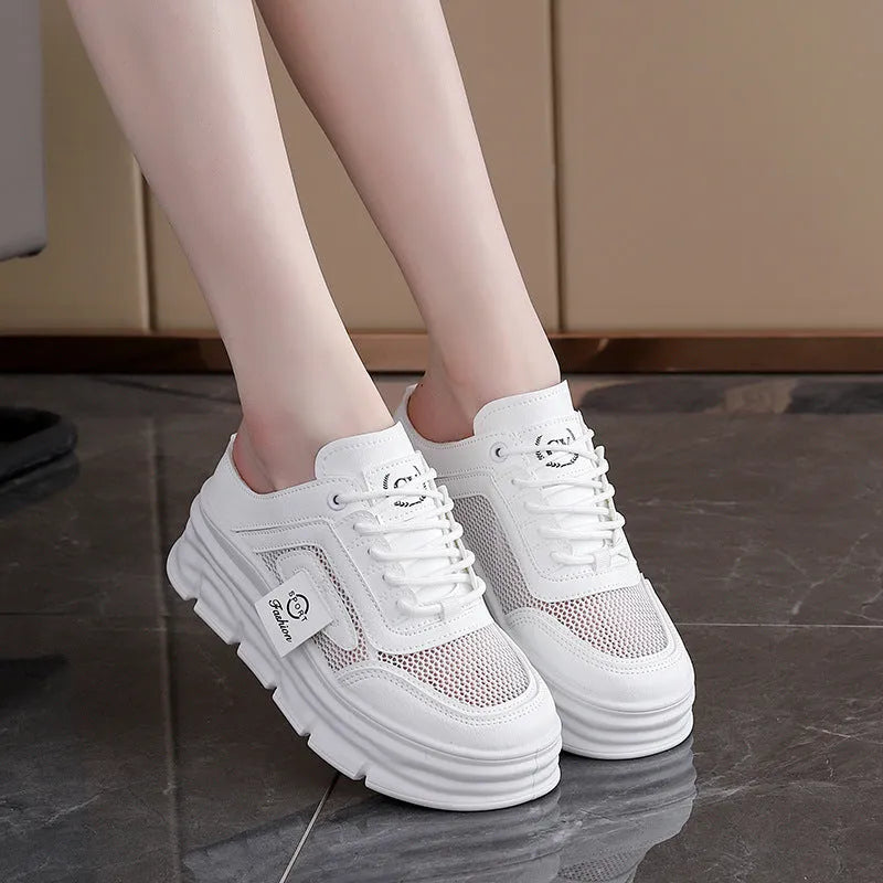 Women's black mesh half slippers with round toe and rubber sole, shown on a foot.