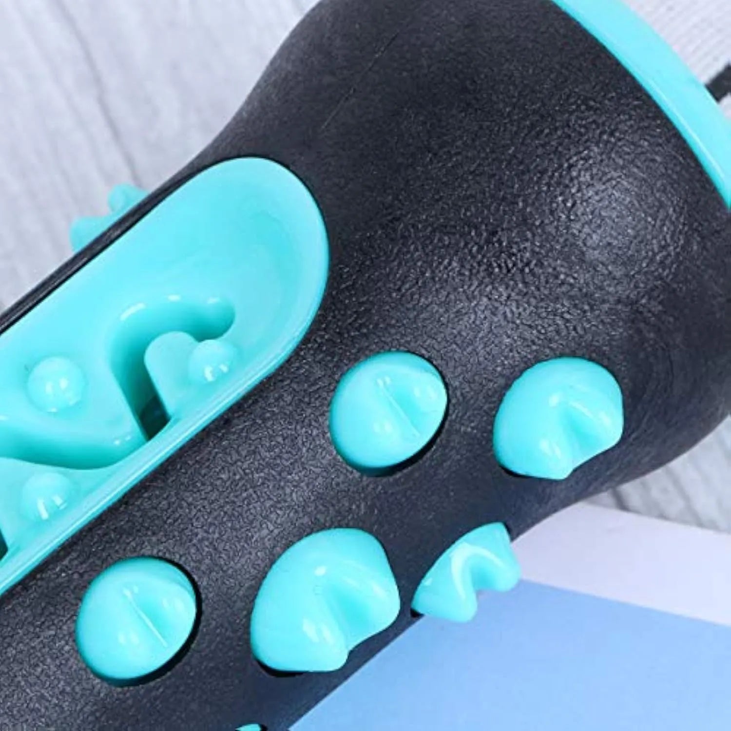 Natural rubber dog toothbrush chew toy for dental cleaning in blue, green, yellow, or black blue.