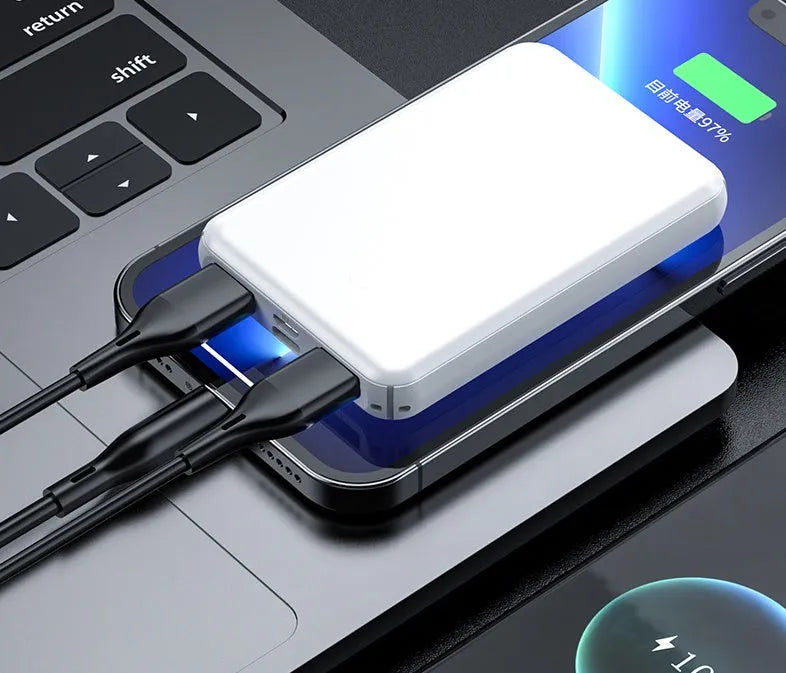 Black electric heating vest power bank with capacity display next to a white vest.