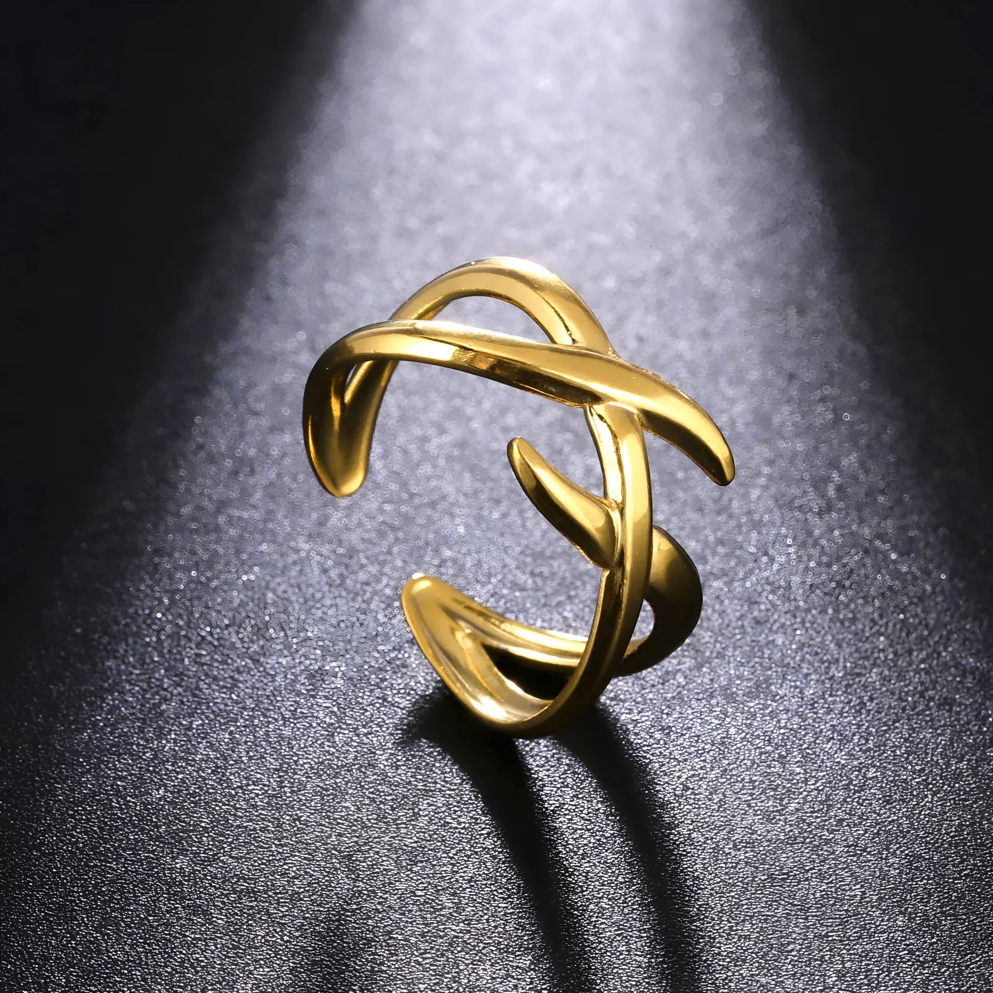 Retro women's stainless steel open ring in gold colour with adjustable opening on white background