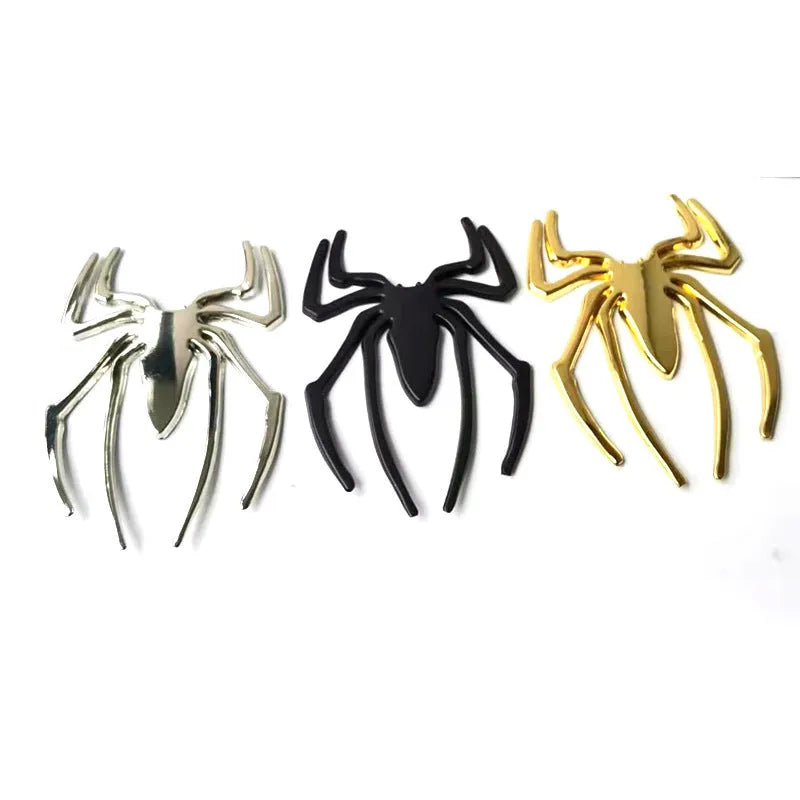Three-dimensional metal spider bumper sticker in silver finish, measuring 7cm by 5cm.