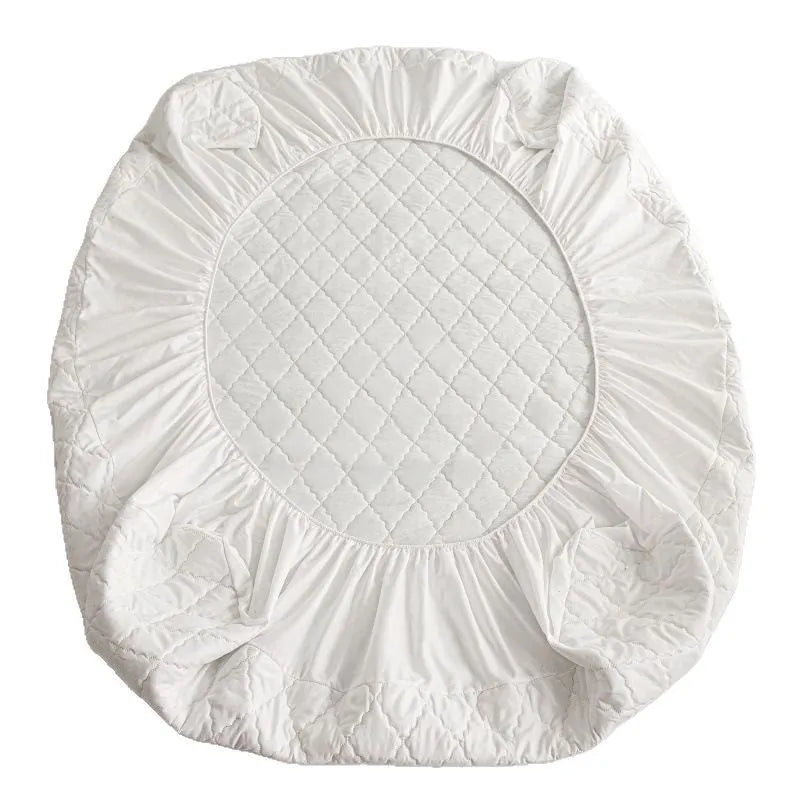 Diamond lattice quilted waterproof mattress protector in bamboo fibre, shown in a solid colour on a bed.