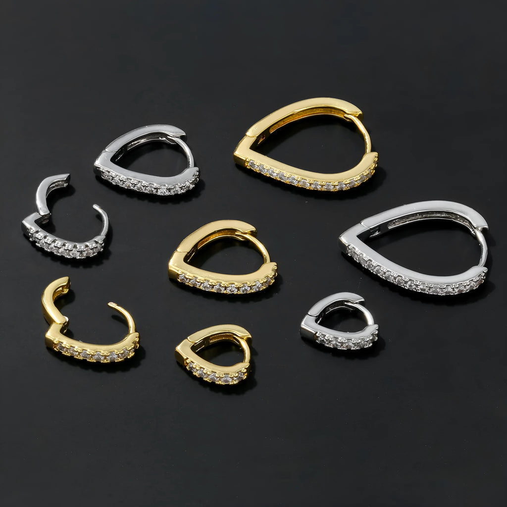 Geometric gold tone love heart clip-on earring for women on a white background.