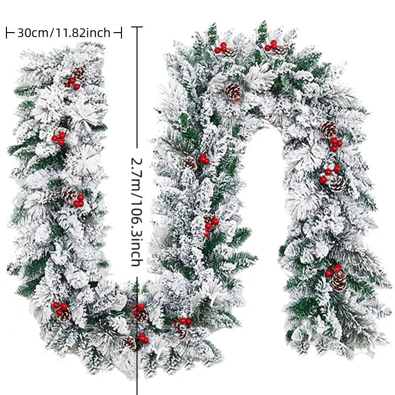 Flocked snow PVC rattan Christmas garland in 1.8 metre length on a mantelpiece with fairy lights