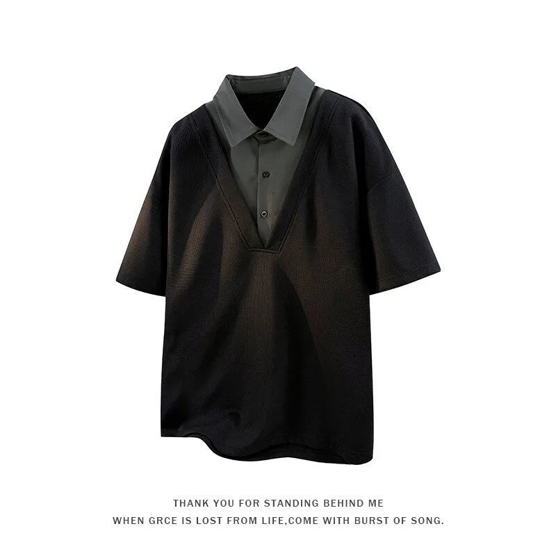 Man wearing a black heavy Henry collar short sleeve polo sweater with padding.